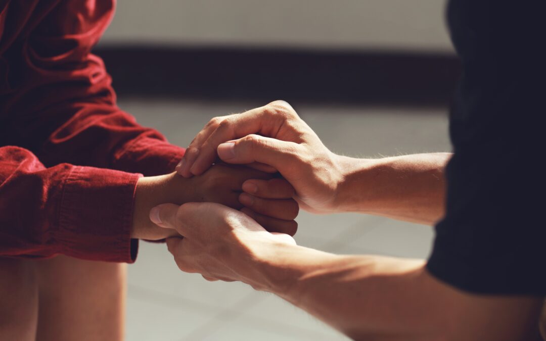 Hands gently holding, representing a supportive gesture for heroin addiction recovery