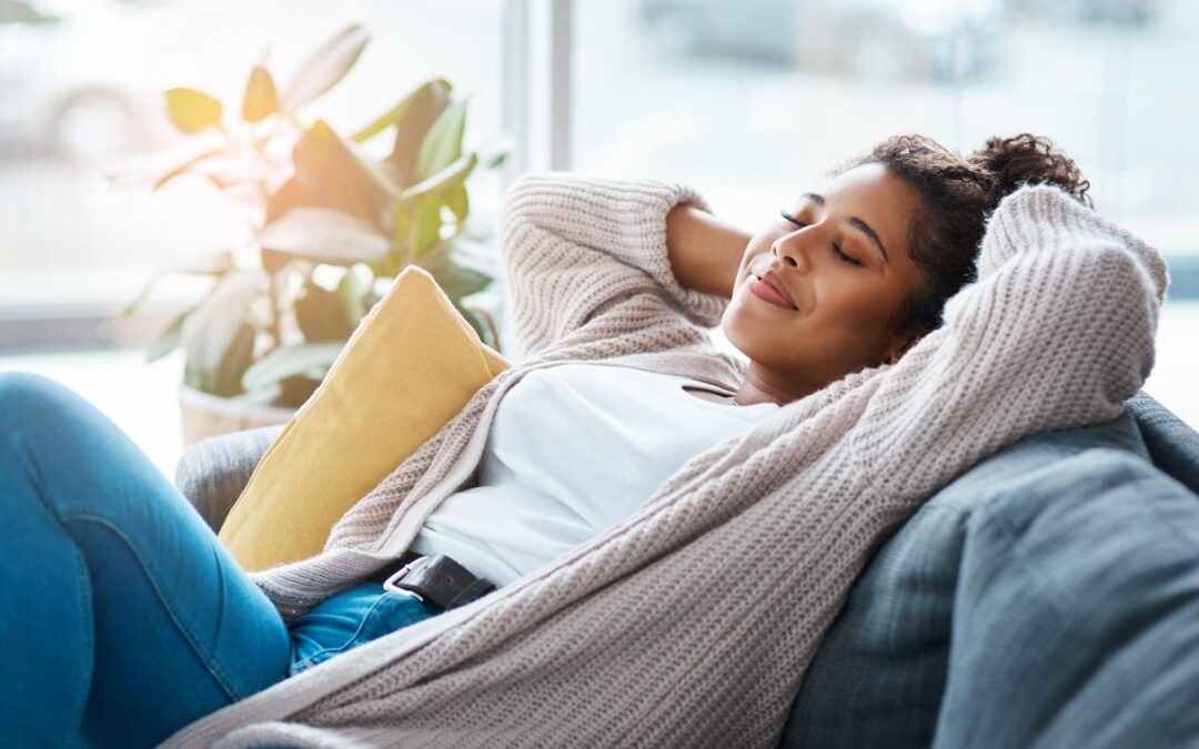 Woman relaxing on a couch, representing comfort and safety during medical detox