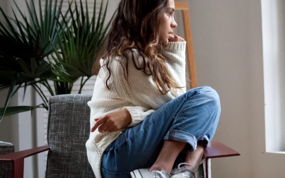 Sad thoughtful teen girl sits on chair